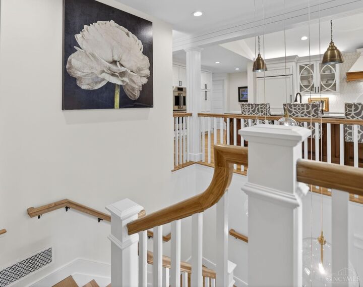Open foyer and staircase with refinished millwork