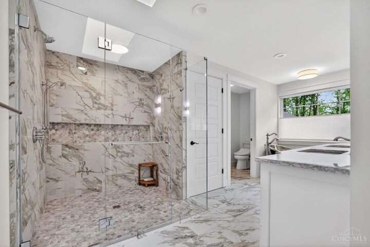 Marble walk-in shower in the owner's bath