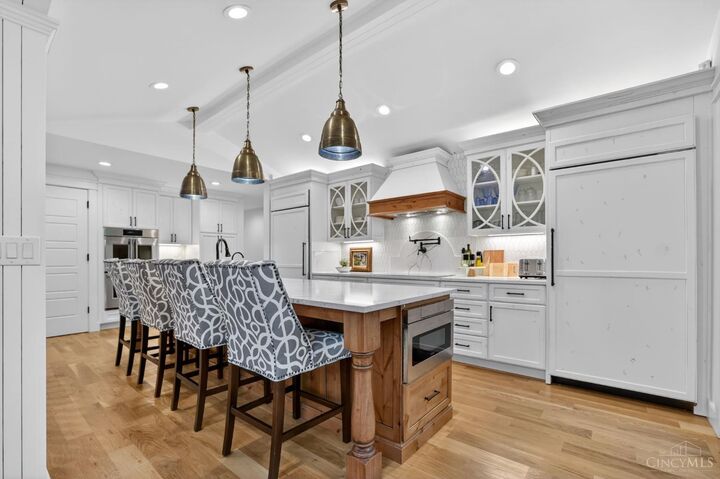 Gourmet kitchen with large center island and quartz counters