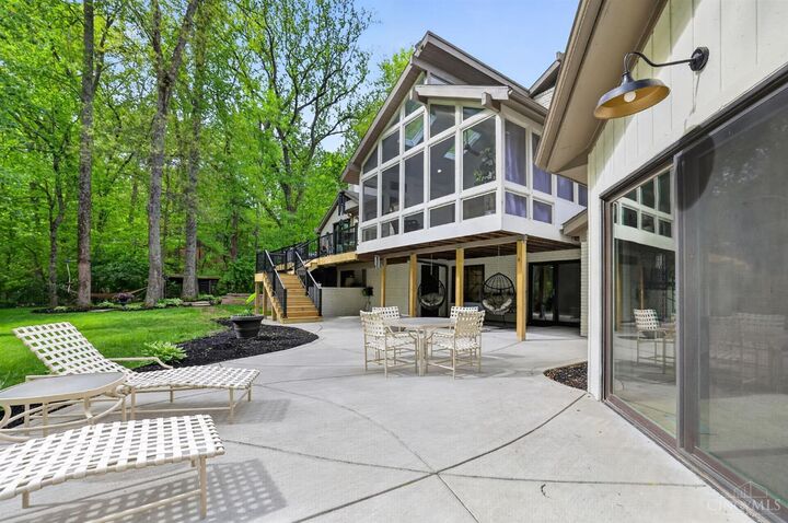 Screened sunroom and paver patio backing to the woods