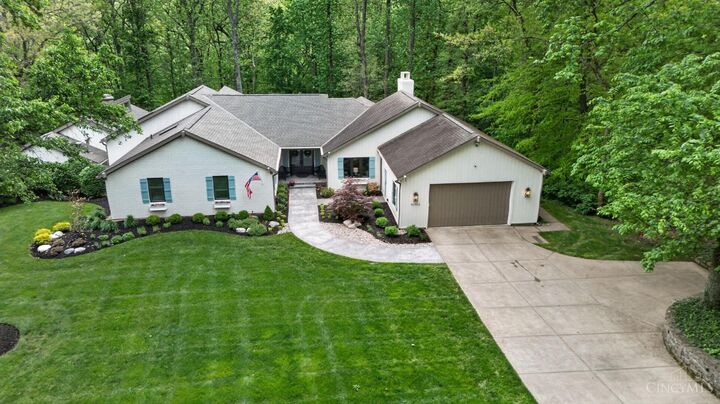 Aerial of the home, drive, and wooded 1.22-acre lot