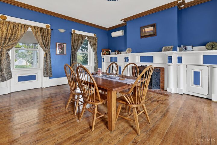 Formal dining room with hardwood floors and natural light