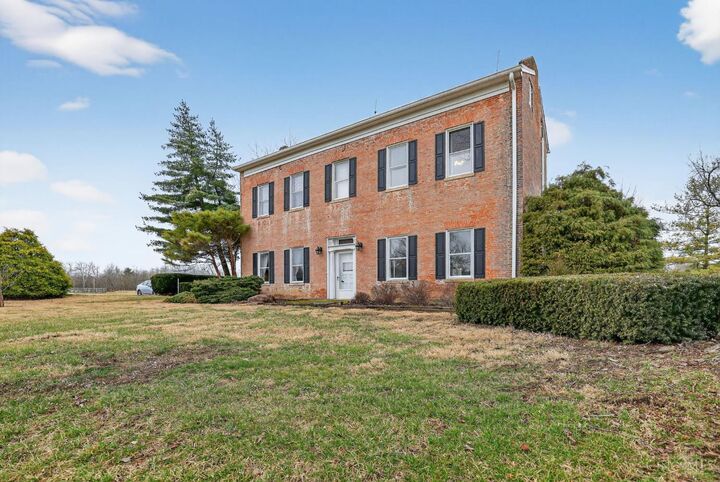 Front exterior of the brick 1839 historic home at 2019 Stillwell Beckett Road