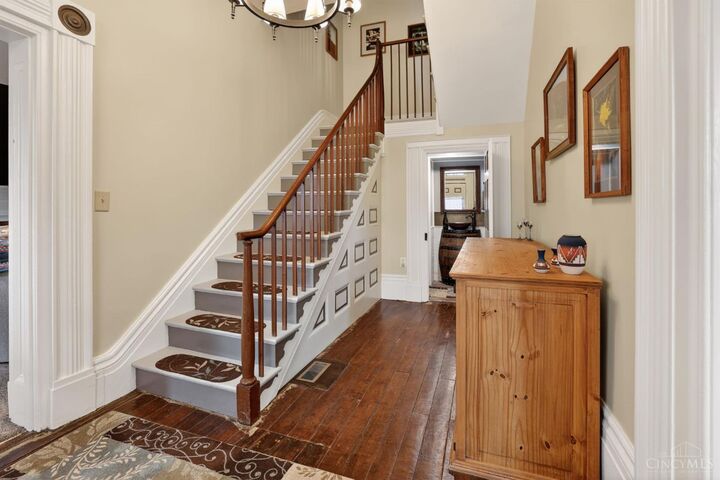 Grand entry foyer with original staircase and refinished hardwood floors
