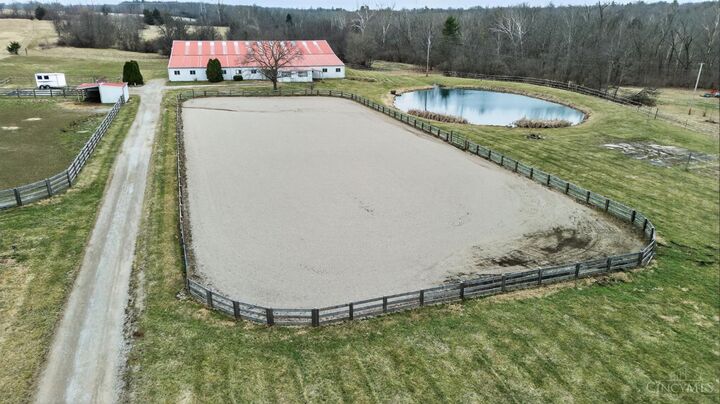 Aerial showing pastures, arena, and pond across the 24-acre estate